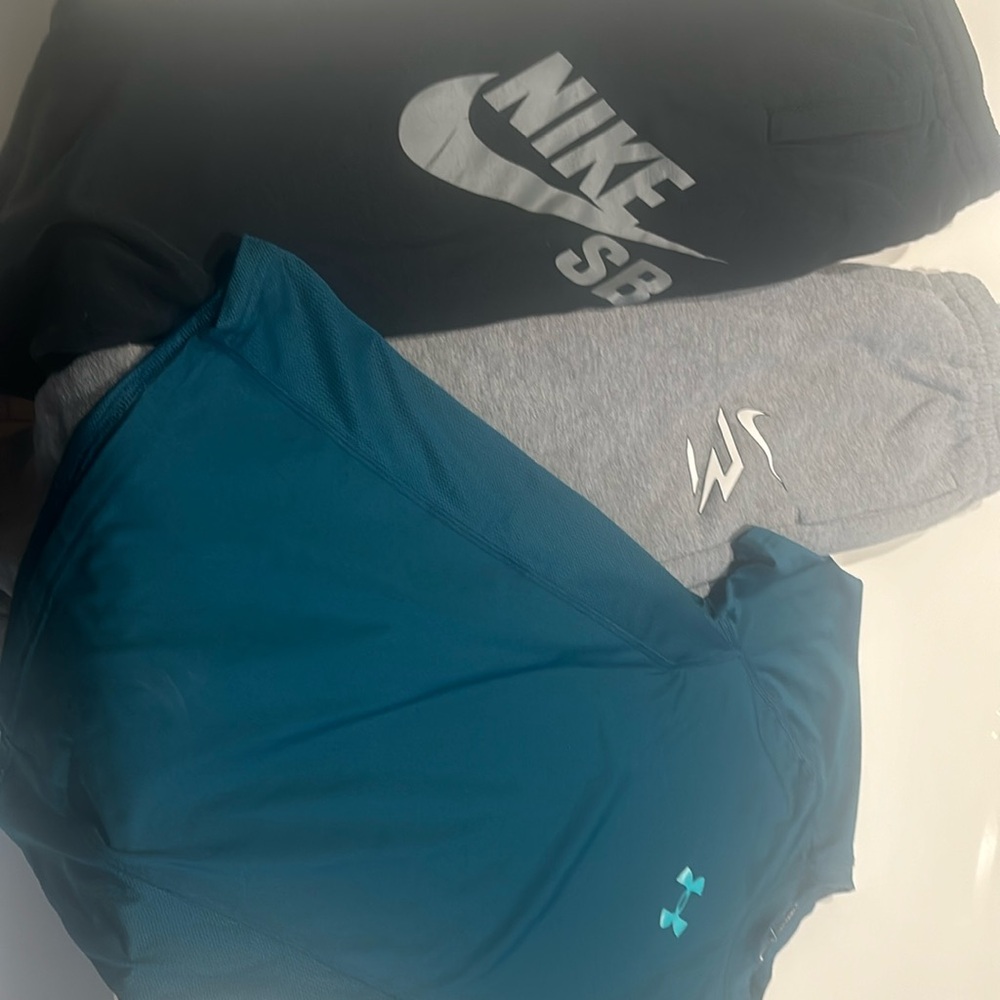 2 Nike track pants and under armour shirt